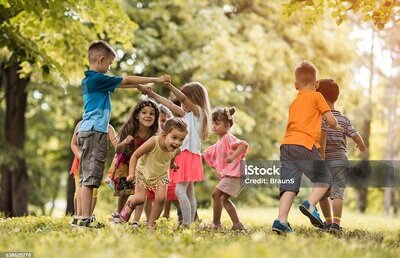 Group of happy little children having fun in the park.